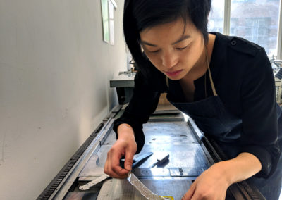 Janine working at a letterpress.