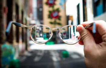 Closeup of glasses looking at a city block