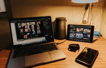 A desk with Zoom opened and various devices