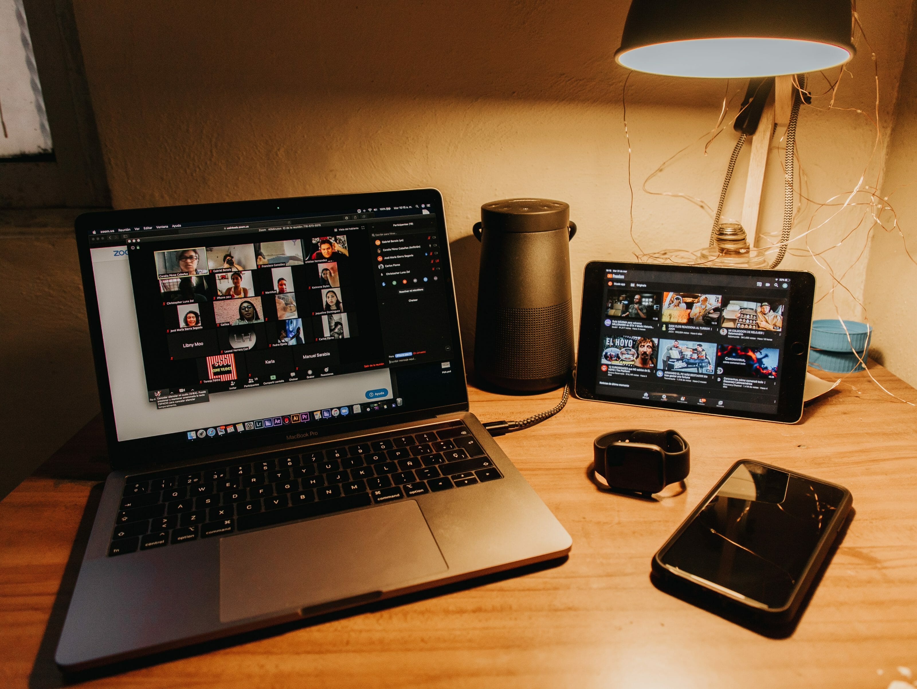 A desk with Zoom opened and various devices