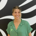 Portrait of a woman in a green shirt with in front of a black and white background