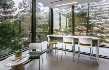 Image from the Common Space Issue of a seating area with a view of a forested landscape.