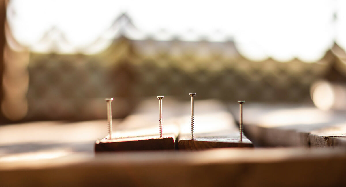 Nails sticking out of wooden boards for construction