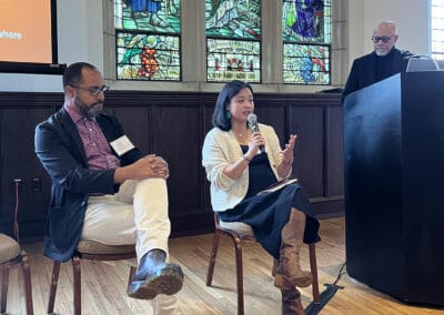 Maria Villafranca speaking during a presentation with George White to her left.