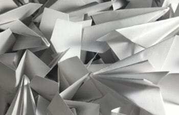 Countless paper airplanes in a pile