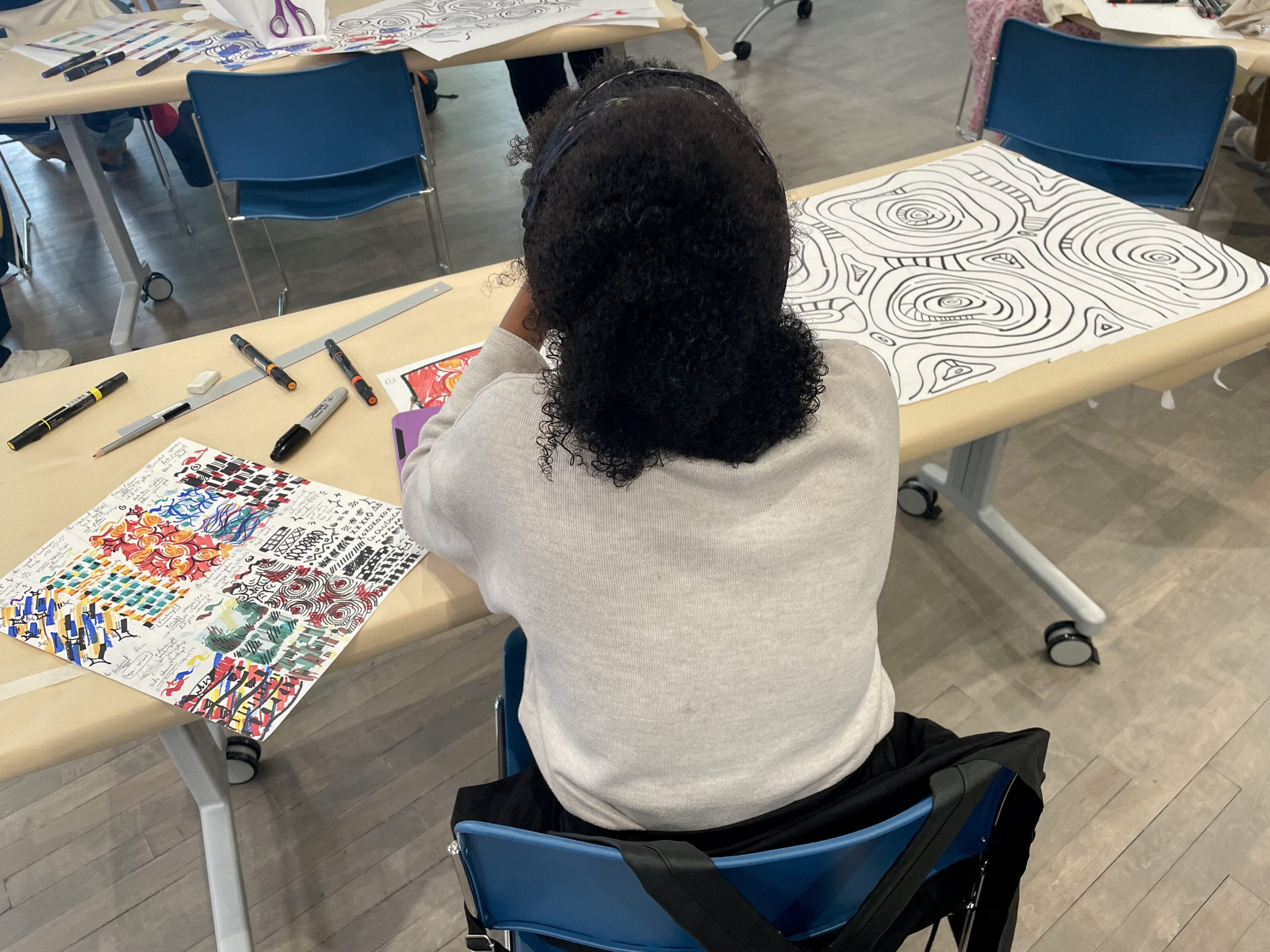 Diverse group of High School students work together on a design project.