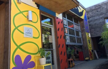 A colorful shop with a yellow and red exterior.