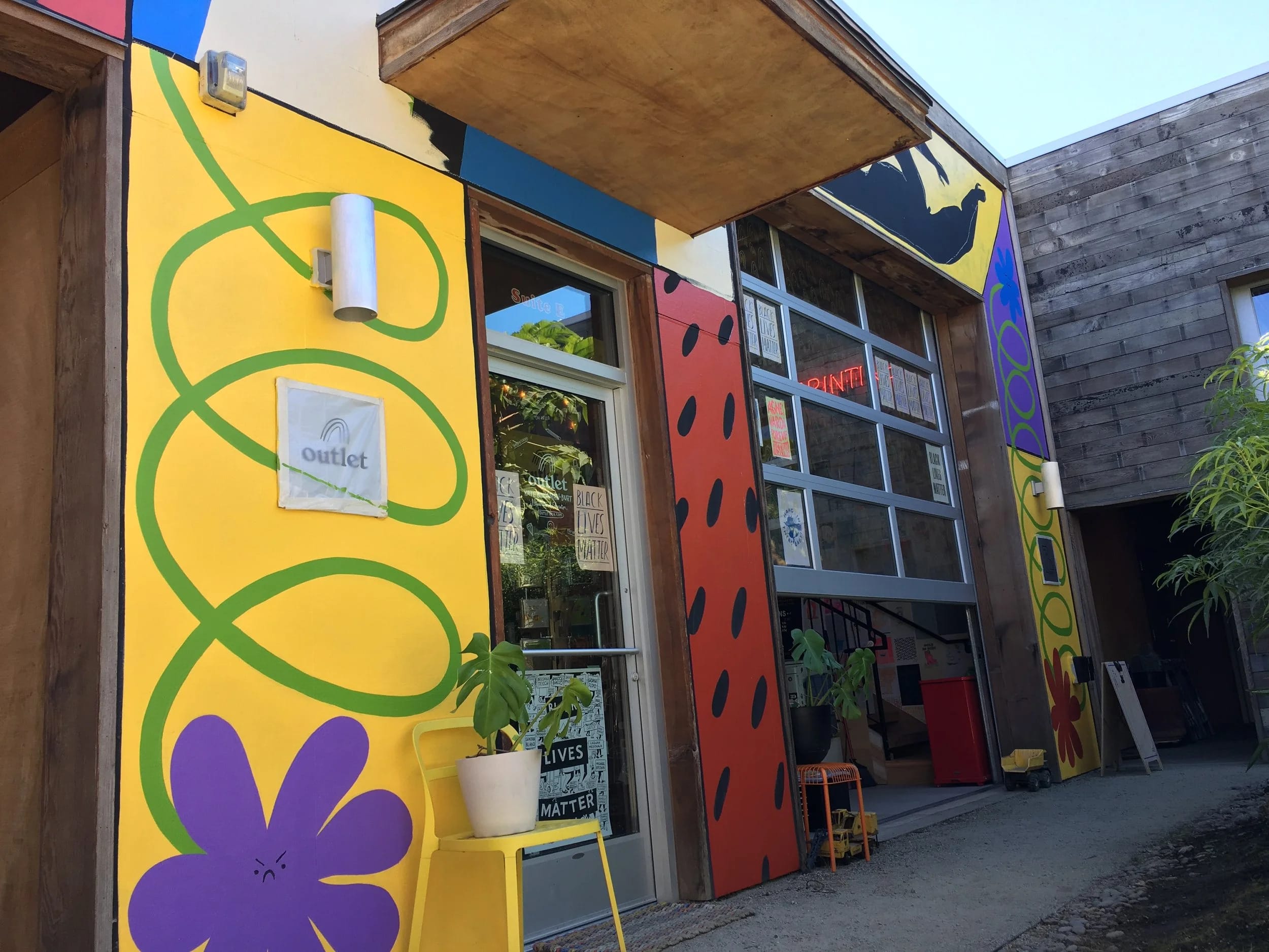 A colorful shop with a yellow and red exterior.