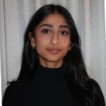 A dark-haired woman wearing a black shirt looks at the viewer
